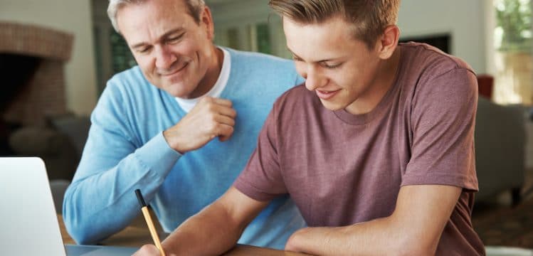 Homeschool father helping high schooler with homework