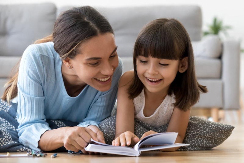 Homeschool mother reading to daughter